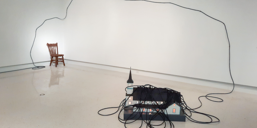 Mistaseni. Wooden chair, wool, horn, electrical cord, plywood, sandpaper, wood, wire, whitewash, paint, adhesive, vinyl, glue, wax paper, electrical fittings, light bulb. 2001-2002. Variable dimensions. SK Arts Permanent Collection